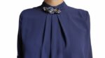 Blusa blu   con un ornamento gioiello sul colletto